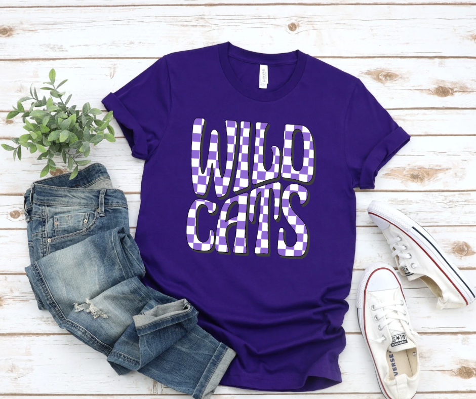 Beaufitil purple t-shirt that says Wildcats in purple and white checkered print.